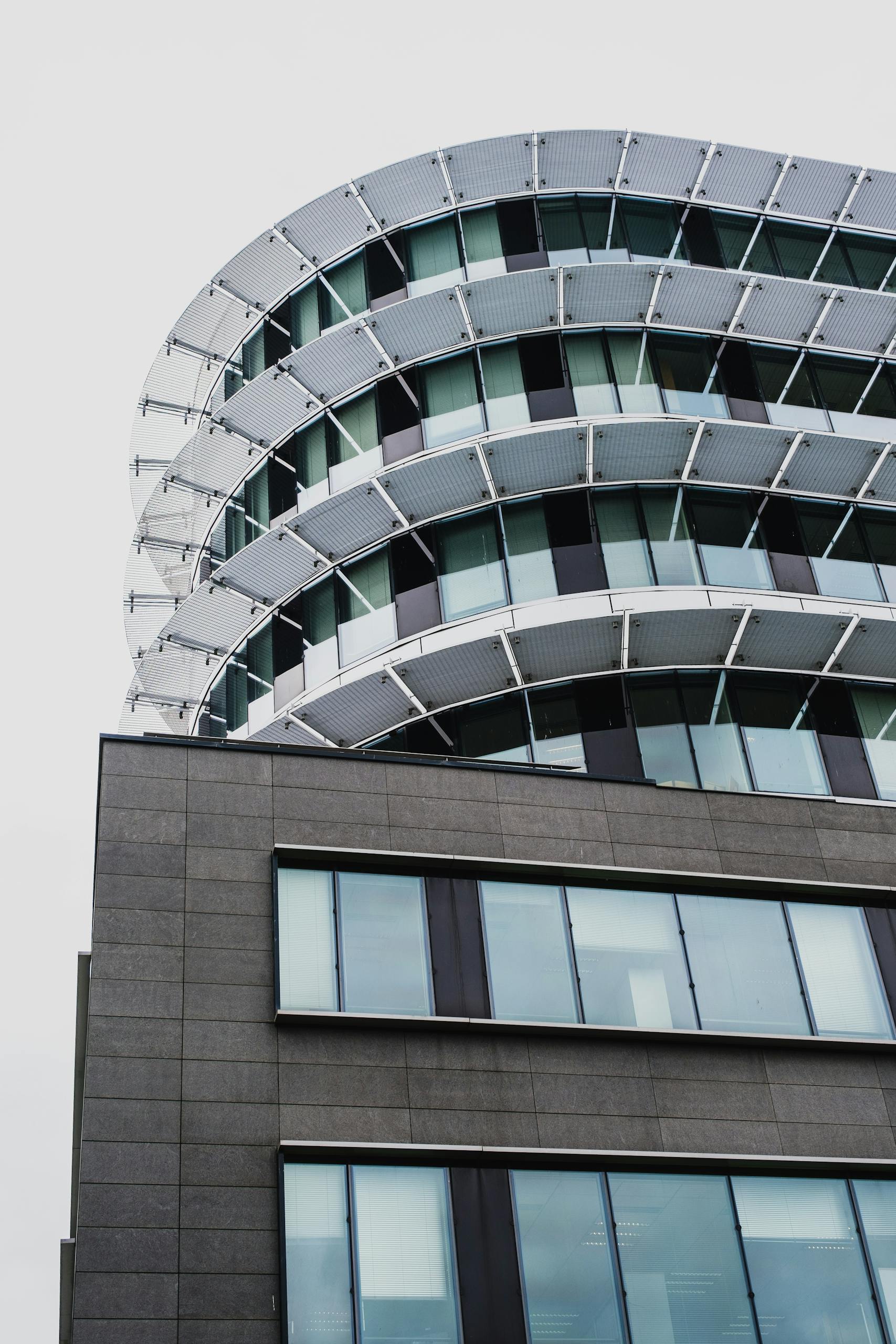 Dynamic view of modern high-rise building with unique architecture and glass facades.